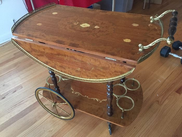 Beautiful tea cart with fold down sides...inlay wood...wine bottle holders on the bottom.  Made in Italy