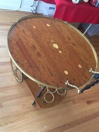 Beautiful tea cart with fold down sides...inlay wood...wine bottle holders on the bottom. Made in Italy. Shown with sides up.