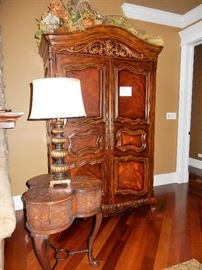 Clover-shaped wood table and hooker armoire