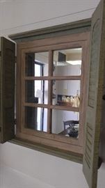 Framed mirror with shutters