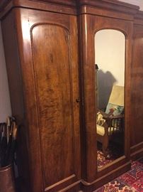 First bedroom:  Copper umbrella stand and vintage wood handle umbrellas.  Antique English three-part, mirrored wardrobe.  The rug is an antique Persian Heriz, 7' x 10'4".