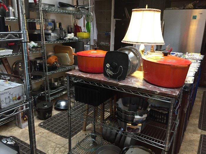 A fully equipped chef's kitchen.  Note the rolling cart with marble top and two huge Le Creuset covered pots.