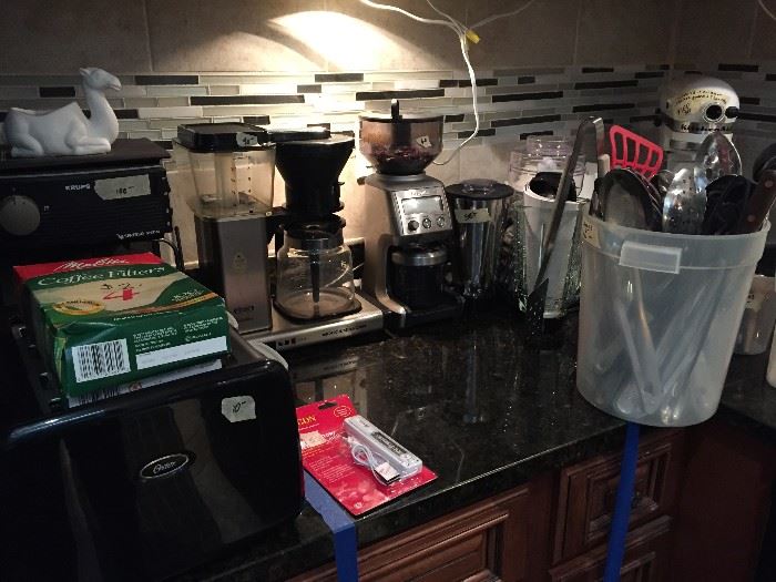 All the small appliances you can imagine:  toaster, coffee makers, coffee bean grinders, spice grinders, Oster blender and Kitchen Aid mixer with all the attachments and accessories.  Need cooking spoons, how about 20 or 30?