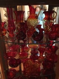 That cabinet is filled with beautiful Red glassware. 