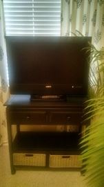 Flat screen Television , small table with shelf and strorage