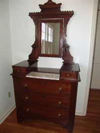 Antique mahogany dresser with marble insert, mirror, 2 wig drawers, and 3 large drawers