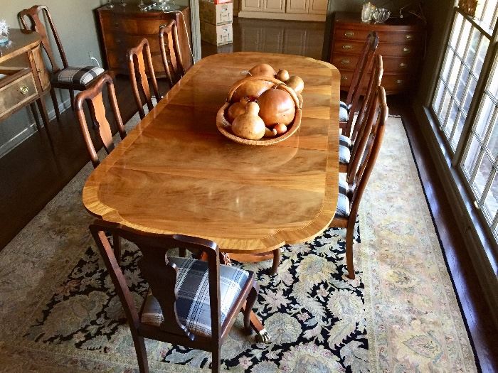 Dining table with two leaves and 10 chairs and large area rug 