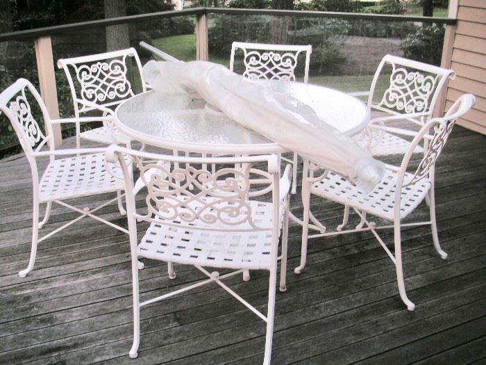 Cast, powder coated metal outdoor patio table with umbrella, stand and six chairs