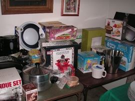 Lots of new items in box: fondue set, mugs, tumblers, glasses, ice cream maker, cake decorating, Tools of the Trade, Showtime Pro rotisserie