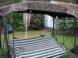 Free standing swing with cushions and weather cover