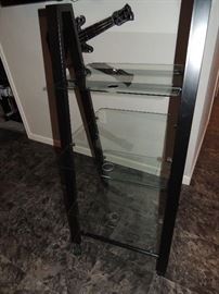 Entertainment stand. Clear glass shelves. There are 2 of these available. $15 ea.