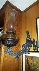 Cast iron swinging sconce and oil lamp