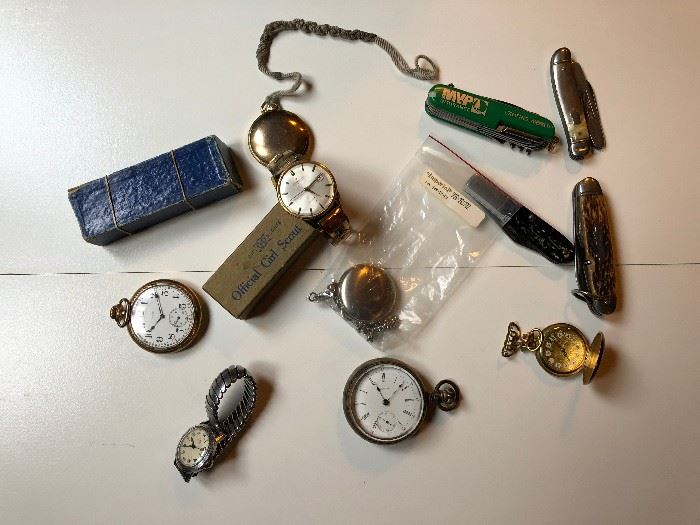 Antique pocket watches and knives.