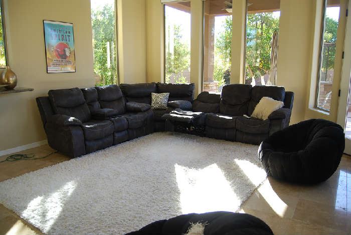 Sectional Sofa with electric recliners.  Dark gray with off white top stitching.  Area Rug.  Swivel Barrel Chairs