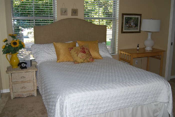 Queen Bed with studded headboard.  Side Table, Linens, Décor.  White table lamp is not part of sale.