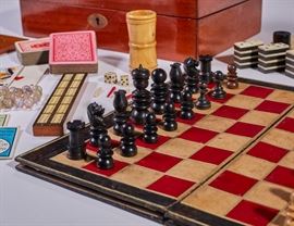  Old Steeplechase Chess 19C Boxed Gambling Games  Steeplechase Chess 19th century boxed toy gambling games. Mahogany box with hinged top. Inlaid oval brass monogram plate on top (blank) and matching inlaid oval brass keyhole escutcheon. Inside divided into nine sections. Contents: 33-hole Solitaire & Tactics board with green fortress design. Reverse side is 50-hole Snail Game with gold filigree. 32 carved chess pieces, 30 Backgammon/Draughts pieces, top has hinged door holding double-folding game board for Chess/Draughts, Backgammon, The Steeple Chase and Go-Bang. Cribbage board, 28 Dominoes, two dice and turned wooden tumbler, two Whist markers, two decks of playing cards,two Bezique registers and six small painted lead horses with jockeys are also included. Some limb loss on horses. Lastly a set of glass marbles and Tiddliwinks are included. Good condition. The folding cardboard game board is separated at folds.Measures 4 inches high x 13.4 inches wide x 8 inches deep.