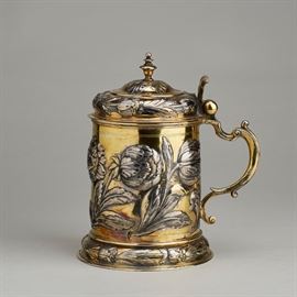 German 1667 Parcel Gilt Coin Silver 17th C. Tankard  German 17th century gilt coin silver tankard has a deep repousse body decorated with peonies and tulips. The interior of the lid has an engraved Coat of Arms and the letters BR and VR and the date of 1667. Marked 12 I on the front of the lid and on the front of the base for .750 coin silver. In good condition, the bottom rim has a light indentation. Weighs 22.7 troy ounces. Measures approximately 8.5 inches high.