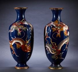 Pair of Meiji period Japanese Dragon Cloisonne Vases  Pair of Meiji period large Japanese cloisonne vases. Pair of large vases with rounded paneled bodies decorated in fine copper wire on rich midnight blue ground. The vases are encircled with dragons with mouths open and talons extended, a band of lappets surrounds the foot. The dragon figures contain goldstone highlights. One vase has an old repair on the round base, otherwise in good condition. Measures 24.2 inches high x 9 inches in diameter.
