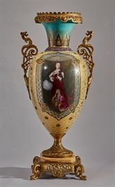 French 19C Enamel Sevres Porcelain Gilt Bronze Urn  Pair of neoclassical style 19th century French bronze ormolu mounted Sevres scenic vase. The vase has oval, hand painted scenic reserves. One side displays a portrait of a finely dressed woman while the other depicts forest glades. The neck of the vase has elaborate arabesque hand painted designs with gilt filigree against a brilliant robin's egg blue ground. The vase also has gilt foliate decoration accented with raised enamel rosettes throughout the body flanked with dragon handles and rests on a marble and Scottish thistle reticulated stepped bronze base with gryphon feet. In good condition. Measures 32 inches high x 14 inches across the bronze handles.