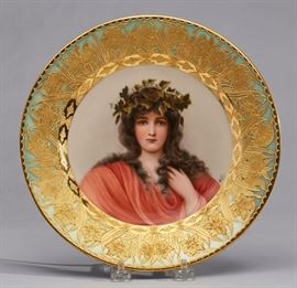 Royal Vienna Porcelain Wagner 19C Portrait Plate     Royal Vienna Wagner 19th century portrait plate Epheu. A finely decorated porcelain plate is hand painted with a beautiful bust-length portrait of a young woman with a peaceful gaze wearing ivy on her head. Signed Wagner at the lower right, within a gold encrusted gilt floral border against a pale celadon green ground. Marked on reverse with Royal Vienna underglaze blue beehive mark and Dec: 766 Depose Register in red oval, Epheu. Good condition, no cracks, chips or scratches. Measures 9.5 inches diameter.