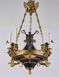 French Empire Style Bronze Six Light Chandelier   French Empire style bronze six light chandelier. Good working order. Neoclassical chandelier is most likely circa 1930's. The chandelier has three patinated bronze angels holding wreaths mounted atop swans. Crown form top with pine cone and flame finials. Measures 32 inches high x 22 inches in diameter. 