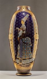 French Sarreguemines Medieval Princess Floor Vase     French Sarreguemines porcelain floor vase depicting Medieval princess admiring her embroidery. The vase has all over, elaborate gilt decoration and stylized floral design on the other side. Measures 23.2 inches high x 9.5 inches in diameter. In good condition.