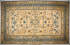  Antique Indo-Persian Inscription 19C Oriental Rug    Antique room size handmade Oriental rug carpet from the late 19th or early 20th century. Antique ivory field accented with a rich blue center medallion of 5 thin borders. Interior of medallion has an elaborate Persian inscription and woven designs depicting baskets of flowers, vases, pictorial mosques and other foliate designs. The decorative geometric borders of rich blue designs are signed with numerous inscriptions worked into the border patterns. Good condition aside from a few thumb sized holes near border and small areas of edge wear, approximately 5 inch cleanly resewn tear. Measures 197 inches long x 123 wide, or 16.4 x 10.2 feet.  