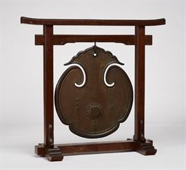 Japanese Kanozan Jinyaji 17C Bronze Temple Gong      Japanese Kanozan Jinyaji 17th century bronze temple gong. The 17th century temple gong comes from Kanozan Jinyaji, located in Narita-city, Chiba -Prefecture, Japan. The gong came from what is said to be the oldest temple in the Kanto area and famous for being on the National Treasures list in Japan. Dated December 21, 1662. The ceremonial gong is mounted on a custom wooden stand, was made for the Chief Priest Enryu upon his request. Made by metal worker Tanka Yamato no kami. The the gong is decorated with a high relief floral medallion on both sides. One side is also decorated with applied Japanese characters, which identify the name of the temple (Jin Ya Ji), the name of the Chief Priest (En Ryu), and the nickname of the mountain where the temple is located (Ka No Zan). The opposite side is inscribed with additional characters down the center. The gong is in good condition and includes a wooden mallet. Measures 25.8 inches high x 22