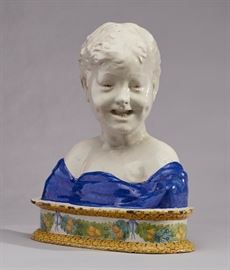 Italian Della Robbia Majolica Pottery Bust of Boy     	
Italian Della Robbia majolica pottery bust of young boy. The circa 1920's bust has an attached plinth that is decorated with hand painted garlands of fruit that encircle the base. There is light flaking glaze along the top rim. Signed underneath with the Cantagalli Pottery Florence, Italy rooster or magic cockerel mark. Measures 12.3 inches high x 10.5 inches wide.

Della Robbia style terracottas. Ulisse Cantagalli (1839-1901) was fascinated by the Italian pottery made during the Renaissance. He had a natural talent and it was easy for him to revive the old techniques. He was also a very intuitive businessman and he knew that Renaissance style pottery was very popular. Even more so the bas-reliefs of blue and white glazed terracotta with religious characters in the style of Della Robbia. Cantagalli and his potters - Romeo Pazzini (1852-1942) is the most relevant one - studied and reinterpreted the works by Luca, Andrea e Giovanni 