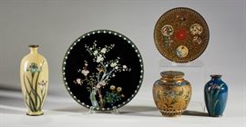 Group of 5 Meiji Period Japanese Silver Cloisonne          Group of 5 pieces of Meiji Period Japanese cloisonne. The first is a round plate with bird perched on cherry blossom branches. Signed on reverse. Good condition with a few light scratches. Measures 7.1 inches diameter. Another round plate with gold stone and phoenix bird decoration. Good condition. Measures 4.8 inches diameter. Next is a filigree enameled signed ginger jar. Good condition. Measures 3.6 inches high. A silver wire iris decorated vase. Good condition. Measures 3.4 inches high. Finally, a yellow cloisonne iris vase. Good condition, hairline crack on vase. Measures 6 inches high. All sold together as one lot.