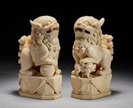 Pair Antique Carved Ivory Chinese Pair Foo Lion Dogs Pair of antique carved ivory Chinese foo lions. The late Qing Dynasty pair of ivory Foo Lions are finely carved. One rests a paw on a decorative ball. The other rests his paw on a foo dog. Good condition. The pair of solid ivory figures weigh 72 troy ounces. Each measure 7 inches high x 4 inches deep. Illicit products made from wildlife are not available for delivery within the United States to states which prohibit same or for international delivery without CITES and other permits which are the responsibility of the buyer.  
