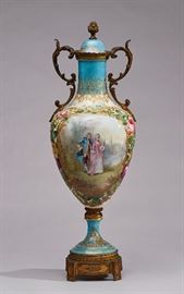 French 19C Enamel Sevres Porcelain Gilt Bronze Urn     Fine 19th century enamel Sevres porcelain gilt bronze urn. The porcelain covered urn features a brilliant turquoise base hue garnished with thick gilded rococo floral motifs, vines and forget-me-not flowers enveloping the center illustration on one side of a finely dressed courting couple strolling through a garden. The other rendering features a meandering creek lined by trees and finished with a scenic landscape backdrop. Finished with mounted dore bronze scrolling acanthus handles with sprouting acorns and rests atop a dore bronze base. Marked on the the bottom of the lid and base with Sevres mark centered by an S. Good condition, the original porcelain top has professional restoration. Measures 22 inches high x 8 inches across the widest point.