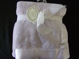 New and never opened satin edged soft and fuzzy baby blanket!