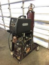 Ironton Glux Core 125 Wire Feed Welder on Rolling cart w/ gloves, apron, helmet, welding beanie ect. Tested Operational.
