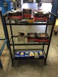 Metal Shelf w/ tire repair parts.

D: 32” H x 24” W x 10” D
