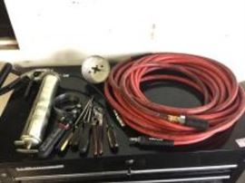 Assorted Tools including grease gun, air hose, oil filter wrench and other tools. Cart not included.
