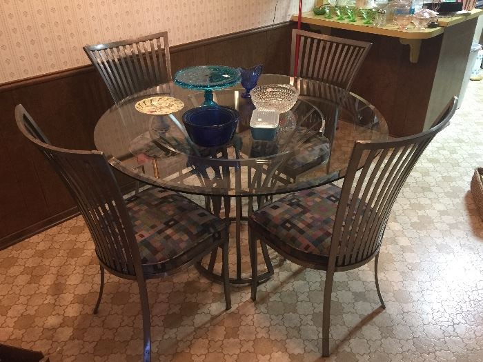 Great Beveled round glass top table and 4 iron chairs