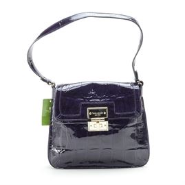 Kate Spade Vanessa Handbag: A Kate Spade Vanessa handbag. This alligator textured purple patent leather bag has a fold-over flap front and silver tone Kate Spade embossed hardware, including a turn clasp. The bag is lined with a woven polka dot fabric and has an internal zippered pocket. The bag bears a Kate Spade leather label to the interior and tags in the pocket reading “S363” and “PXRU1477.”