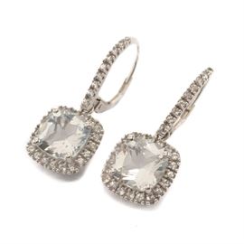 14K White Gold Cushion Cut White Sapphire Drop Earrings: A pair of 14K white gold earrings featuring a cushion cut white sapphire drop surrounded by additional scallop set white sapphires.