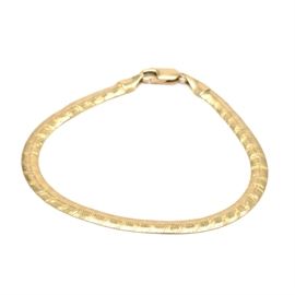 14K Yellow Gold Herringbone Bracelet: A 14K yellow gold herringbone bracelet. This bracelet features a herringbone chain with a lobster claw clasp.