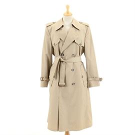 Vintage Christian Dior Monsieur Trench Coat: A vintage Christian Dior trench coat. This classically-styled double breasted khaki canvas trench has button down storm pockets, notched lapel, epaulet and sleeve straps, and is finished with tortoise shell pattern buttons. The coat has a detachable wool lining and bears the “Christian Dior Monsieur Paris, New York” satin tag sewn to interior.