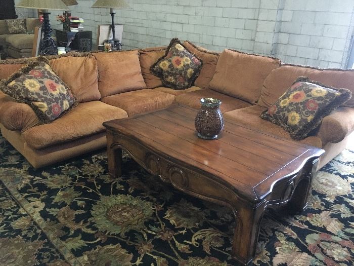 Custom made Rene Cazares sectional, carved detailed wood coffee table, on a dark blue palmette design Oriental rug