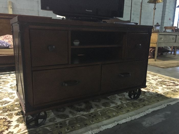 low cabinet with great details including barn type or steam punk wheels.