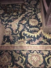 Detail image of wool pile Oriental rug with palettes and meandering vine motif on a black ground