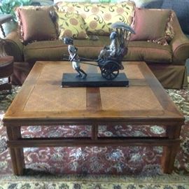 Close up image of four paneled contemporary Chinese coffee table with bronze rickshaw sculpture