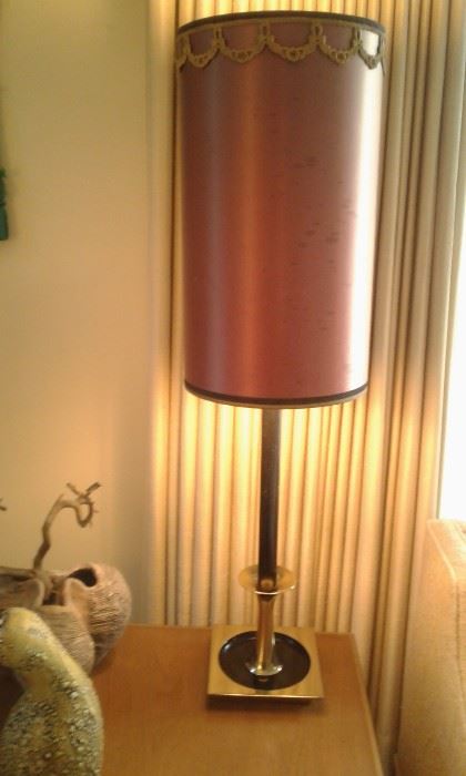Lovely paired 1960's lamp with brass base and original lamp shade which are staged on paired Mid-Century lamp tables.