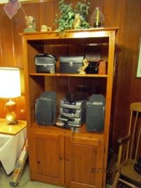 Bookcase with electronics, speakers, Movie Camera, binoculars.