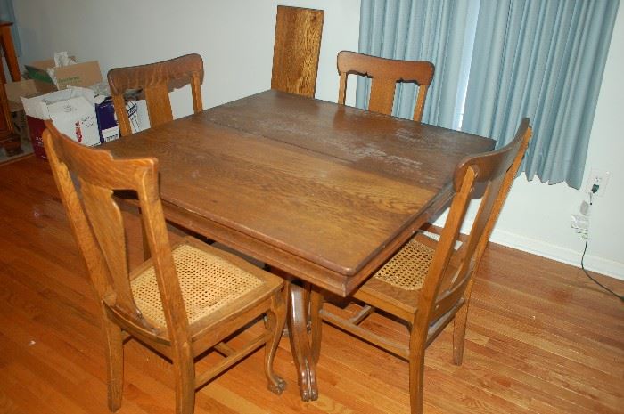 Antique Rectangular Oak Pedestal Dining Room Table with Four Matching Weaved Bottom Straight Back Chairs