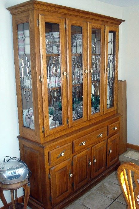 Oak china cabinet with leaded glass doors.