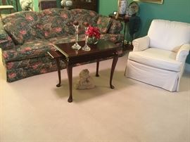 Upholstered sofa, coffee table and chair in living room